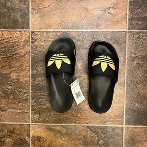 Adidas black and gold slides